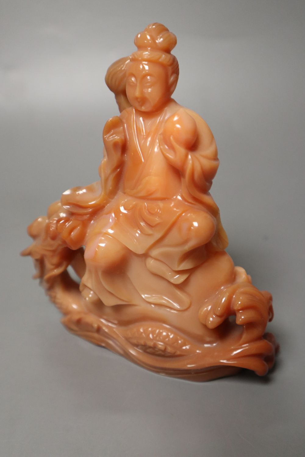 A Chinese chalcedony carving of Guanyin and a dragon, 13.5cm high